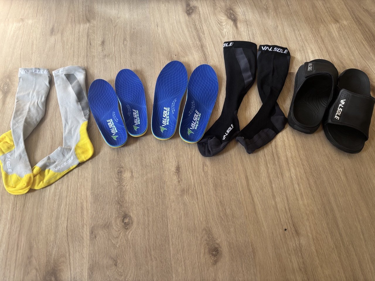 VALSOLE Heavy Duty insoles, Compression Max socks and Recovery Slides arranged together.